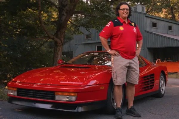 Man standing in front of sports car